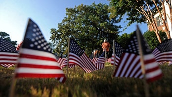 Massachusetts family honors coronavirus victims with 8,013 flags in front yard