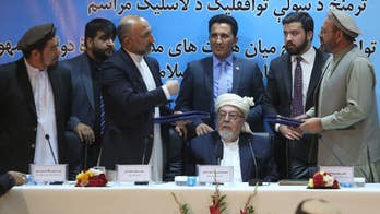 Afghan government signs draft peace deal, first since 2001