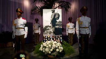 Historic photograph of Fidel Castro at center of memorial