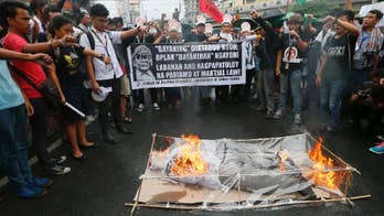 Nude students, Filipino activists protest dictator's burial