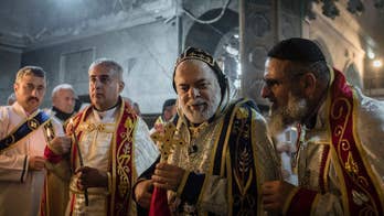 Displaced Iraqis return home for 'wartime' Christmas mass