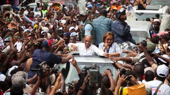 Aristide joins Haiti rally to urge voters to back candidate