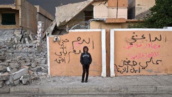 Hundreds of Iraqis line up for food in Mosul after IS battle