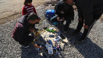 Silenced by IS, displaced Iraqis relish return to phones