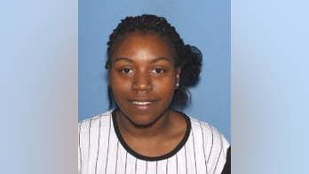 Woman charged after dead twins found in suitcase along roadside