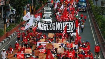 At site of 1986 revolt, Filipinos protest Marcos burial