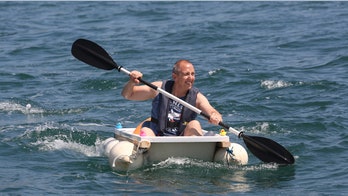 Plumber rows across harbor in bathtub to raise money for cancer