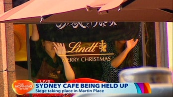 Black flag held by Sydney siege hostages bears Islamic message of faith