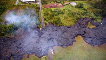 Hawaii lava flow is slow, gentle yet unrelenting as it edges close to town's road, homes