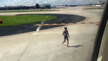 Nearly naked teenager charged for jumping on wing of plane at Atlanta airport