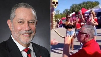 College president apologizes for viral video of him drinking from beer bong while tailgating
