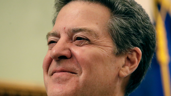 Kansas' Brownback still touts tax cuts as he heads to exit