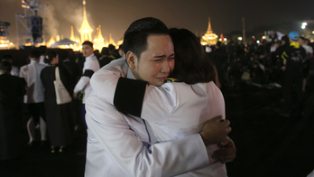 Thai king's charred bones bathed before enshrinement
