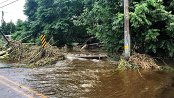 The Latest: Winds die down, rain still a threat in Hawaii