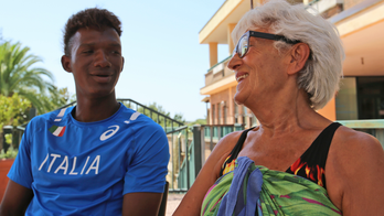 Opening door to migrants, some Italians defy government line