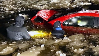 Driver rescued from car quickly sinking into icy pond