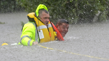 The Latest: Houston officials: Hunker down, stay off roads