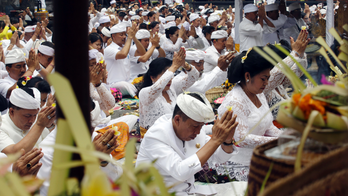Dozens pray at Hindu temple on slopes of Bali volcano