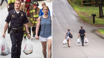 Police officer goes the extra mile, carries woman's groceries uphill after fire