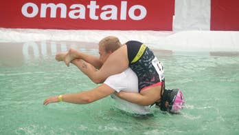Carry on running: Finnish couple wins international 'wife carrying' obstacle race
