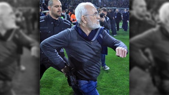 Owner of Greek soccer team apologizes after running onto field with holstered gun to protest goal