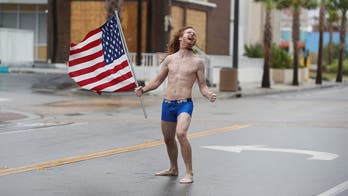 Shirtless man stares down Hurricane Florence with American flag in hand: 'Just being free and American'