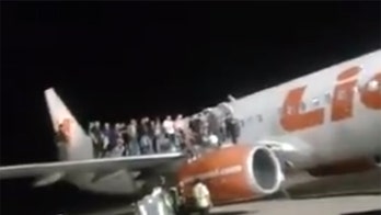 Lion Air passengers suffer broken bones and head wounds after man makes false bomb threat