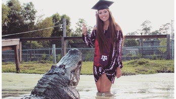 Texas student plays with giant gator in graduation pictures: 'He's a real life dinosaur'
