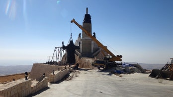 In midst of Syrian war, giant Jesus statue arises