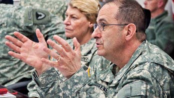 Body of US general killed in 'insider attack' in Afghanistan arrives at Dover Air Force Base