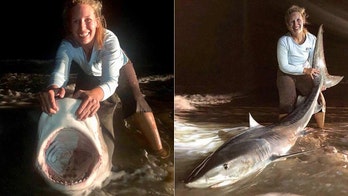 Woman in Texas catches 8-foot 'dream' tiger shark, wild photos show