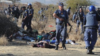 South Africa police fire at striking mine workers