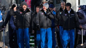 Russian rocket docks at space station with fresh crew