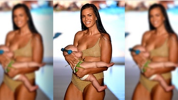 Sports Illustrated swimsuit model breastfeeds baby while walking down the runway