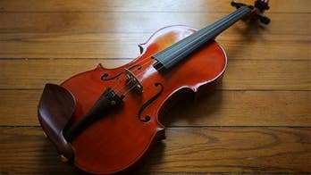 Woman plays violin as surgeons operate on her brain