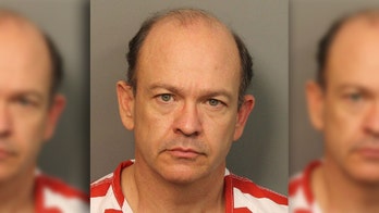 Lawyer in hazmat suit who threatened to slice hostage's genitals with bolt cutters sentenced, report says