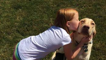 Ohio girl sets up kissing booth with family dog to raise money for cancer