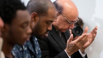 The Latest: Clinton supporter Khan goes after Trump in VA