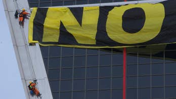 Activists scale Madrid building to protest US trade talks