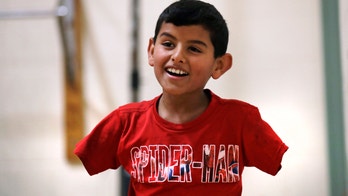 Armless Syrian boy thrives in US, hopes family can join him