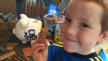 Boy gets service dog after saving pennies for 4 years