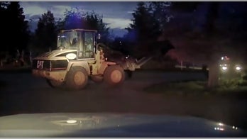 Suspect accused of using front-loader to bust into liquor store