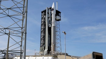 Space station supply ship at launch pad honors John Glenn
