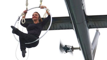 Wallenda daredevil dangles over Niagara Falls by mouth, breaking record