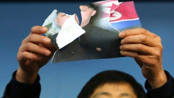 Activists rip Kim Jong Un's photo in Olympic protest