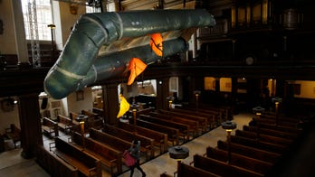 London church hangs deflated dinghy in powerful reminder of refugee crisis