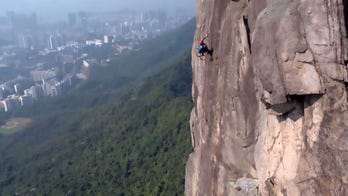 Paraplegic athlete climbs cliff in wheelchair