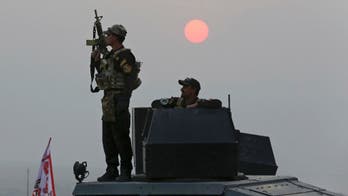 Iraqi forces battle IS in western town, far from Mosul