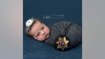 Baby wears uniform of police officer who delivered her in newborn photos