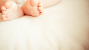 Mom charged after 6-month-old dies in her bed